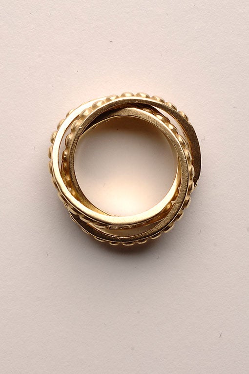 Rolling rings with raised circles and diamonds by American designer, Judith Ripka. Eighteen karat gold. Size 7 1/2.