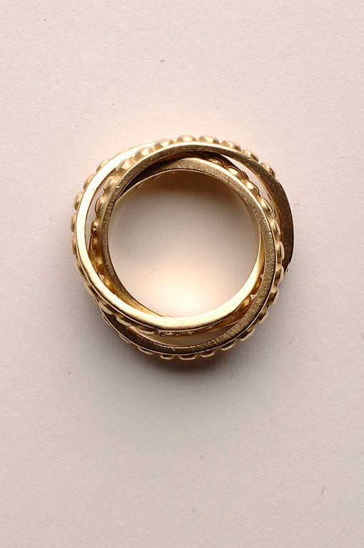 Rolling rings with raised circles and diamonds by American designer, Judith Ripka. Eighteen karat gold. Size 7 1/2.