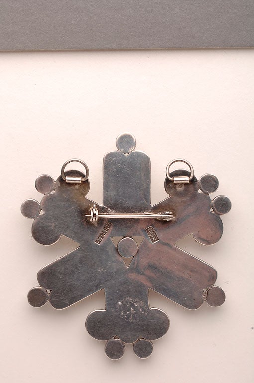 Large brooch that also has rings to allow it to be worn as a pendant.