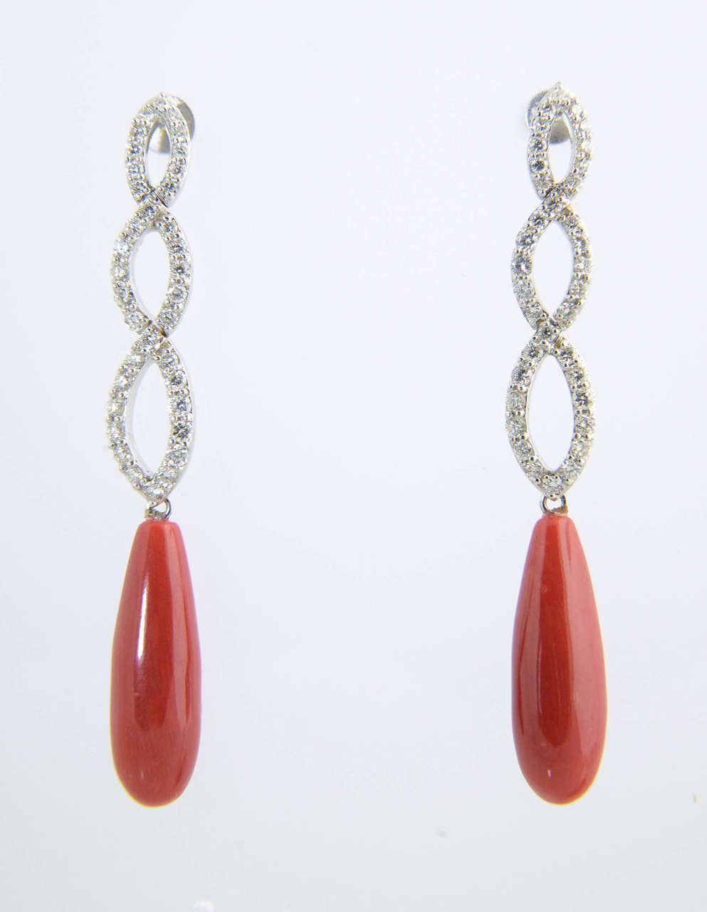 Signed 18k Fred & Co., 2 carat diamond twist that terminates in a coral drop set in 18k white gold.

Post backs