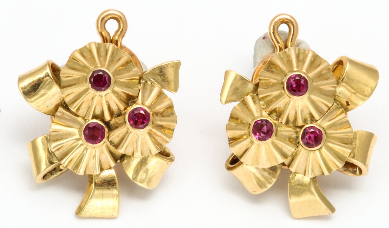 A beautiful pair of Ruby and Gold earrings signed by Van Cleef and Arpels. These pair of earrings are very rare and unique. These earrings were made in the 1940's.