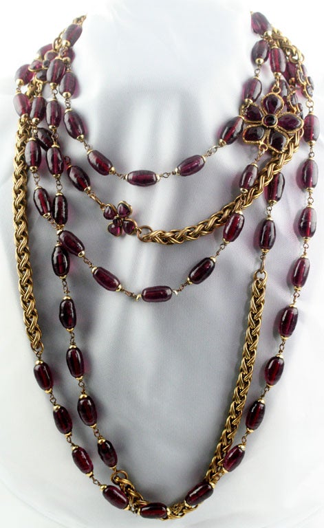 A stunning and rare amethyst poured glass bead and camelia with gilt metal rope sautoir by Chanel. At 106