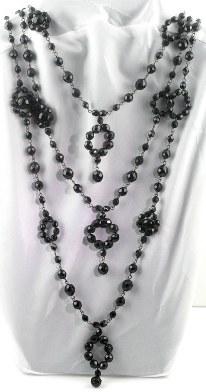 A beautiful, rare and unique triple strand black jet necklace by Giorgio Armani. All of the beadwork is done by hand.
