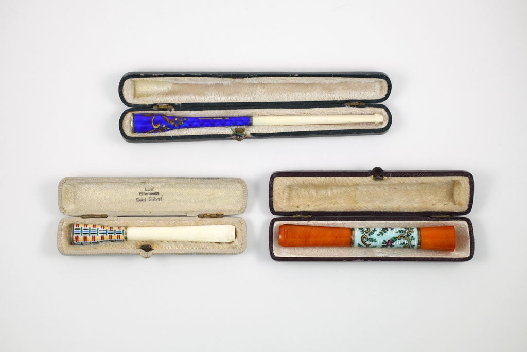 You do not need to be a smoker to appreciate the beauty of these cigarette holders. Each cigarette holder is unique. The first is amber and enamel on silver (with a slight repair to the amber); the second is Ivory and enamel with gold-washed silver