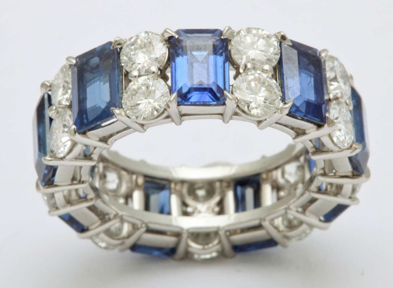 Platinum band featuring 9 emerald cut sapphires, 6.74 carats, and 18 round cut diamonds, 2.98 carats. 

Size 5 1/4. Can be sized.