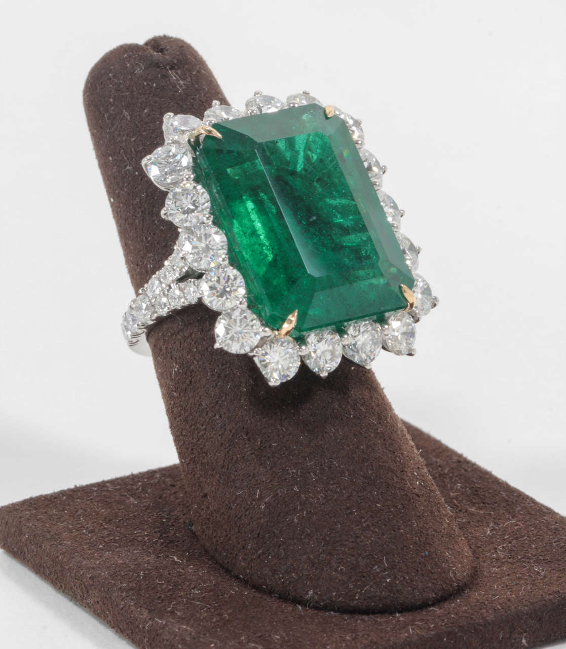 An incredible ring!

Featuring a rare 26.56 carat Emerald cut Green Emerald with Fine color. 

This massive stone is set with over 5 carats of F-G VS clarity round brilliant cut diamonds set in a custom platinum mounting.

Certified by Christian