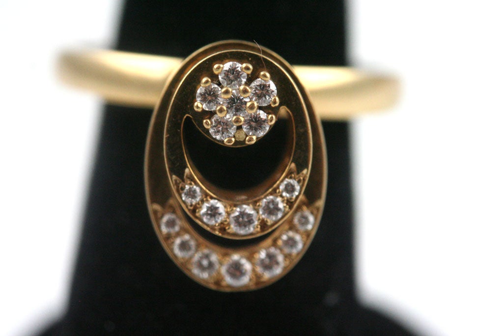 A kinetic ring of 14k gold set with a total carat weight of approximately .5 carats. The post projects approximately 3/8