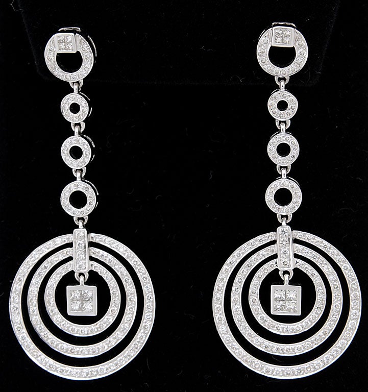 Delightful dancing diamond circle dangle earrings set in 18k white gold. 2 Carats approximate diamond weight.