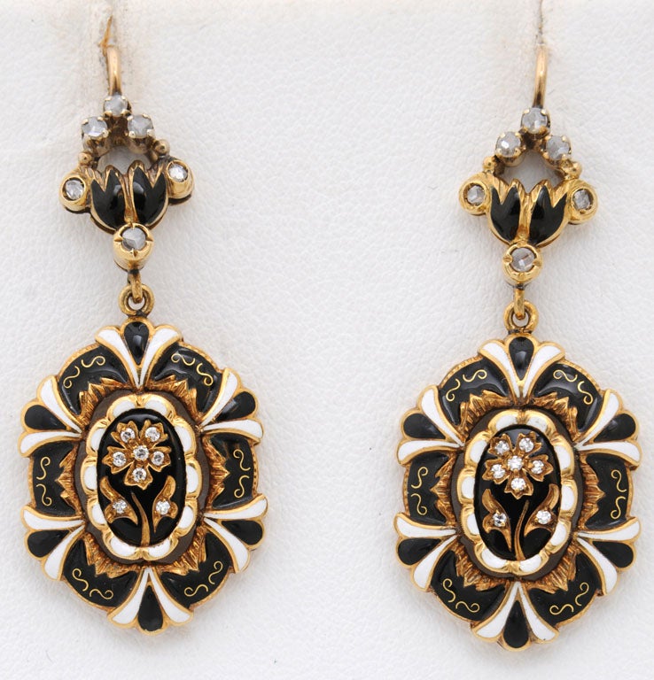 Beautiful Black and white enamel earrings with a diamond flower in center.  The earrings are 18k gold.