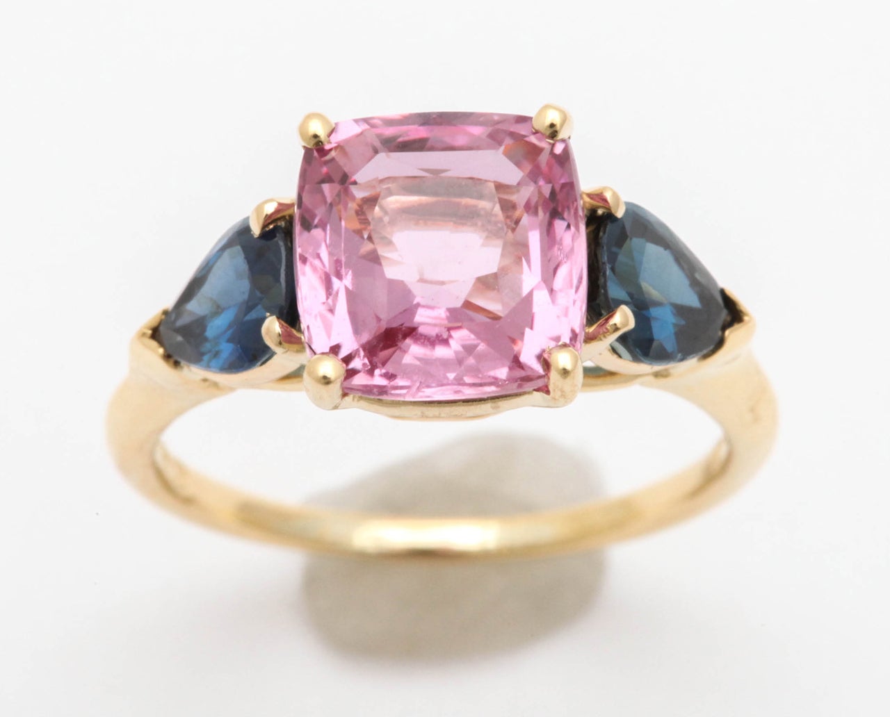 18k Yellow Gold Mount centering a Cushion shape Pink sapphire 3.60 carats
Flanked by 2 pear shape blue Sapphires 1.32 carats