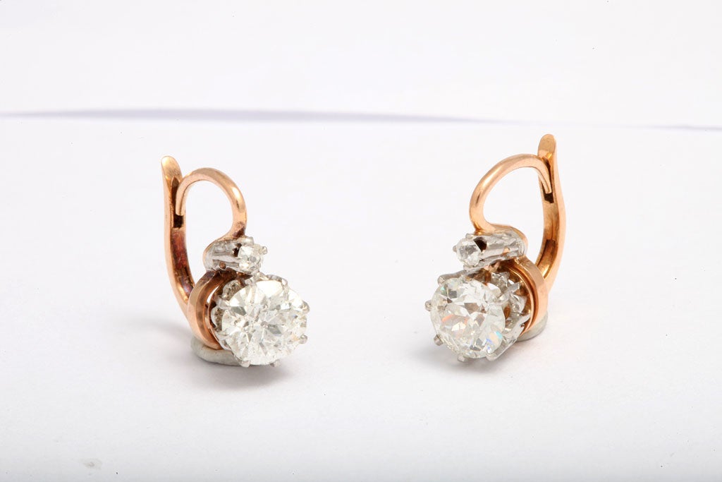 18kt 2 stone diamond earrings each with a .75ct diamonds on the bottom and .10ct of diamonds on the top.