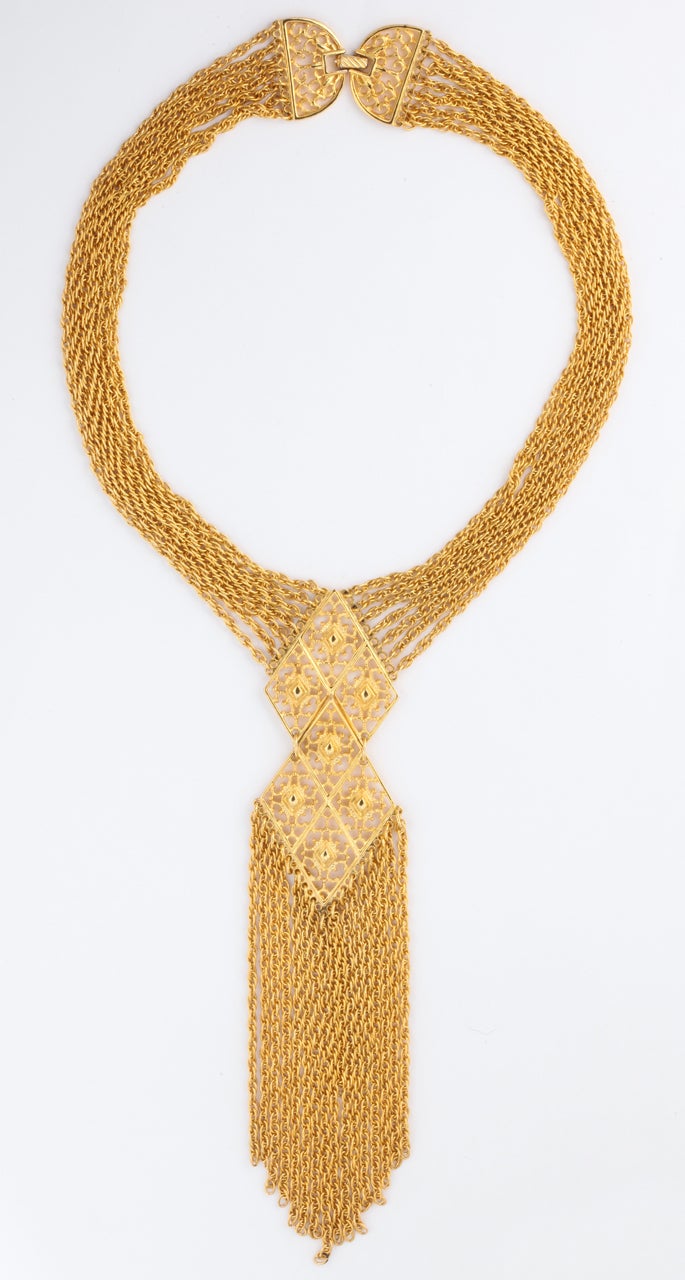 Seven strands of fine chain with a double diamond shaped decoration and 17 strands dangling. 17