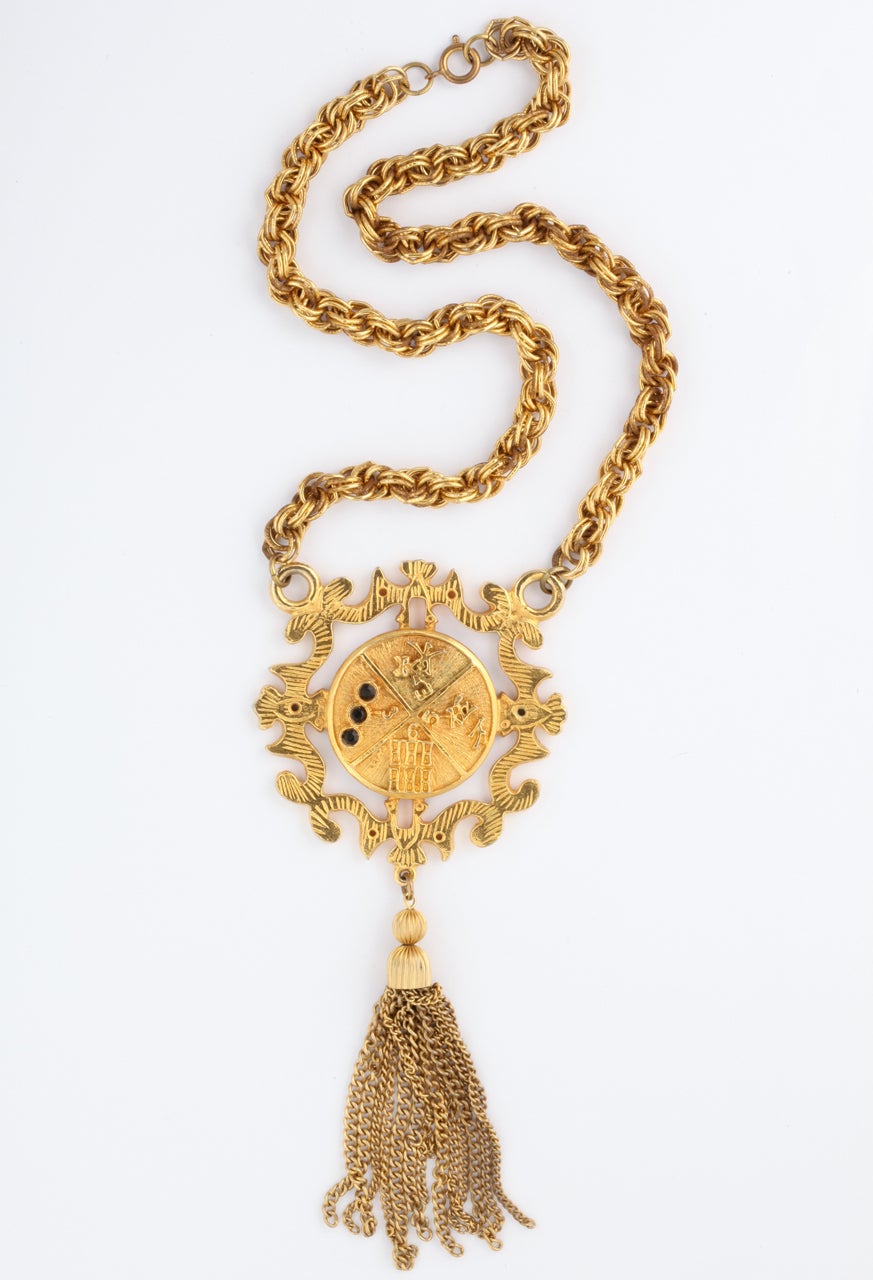 1960's goldtone shield medallion necklace with large tassel and three black stones. Never worn. The original Wieboldt's tag is on it. Opening of chain is 20.5