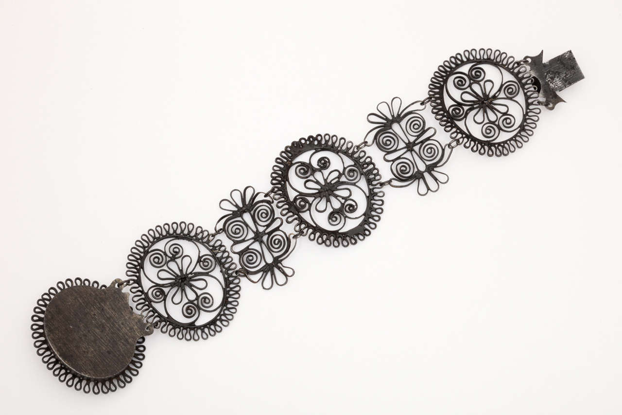 A winged lady (Psyche?) graces the clasp of swirls that mirror the curls of her hair on this wondrous Berlin Iron Bracelet. All Berlin Iron in excellent condition is rare. Museums own the most examples extant. The V&A, The Rouen Museum, The