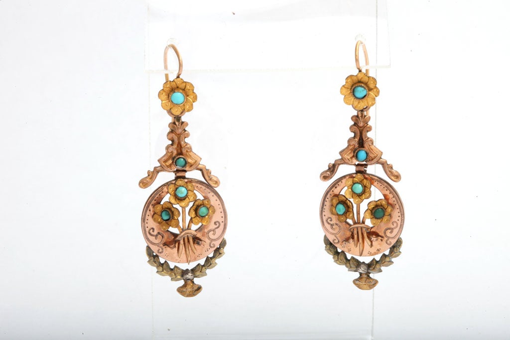 Flowers everywhere!  These charming earrings are Victorian. Single posies rest at the earwire to announce your arrival. Below, amidst the engraving and in relief are bouquets of the same, all with turquoise centers. The two lower sections are made