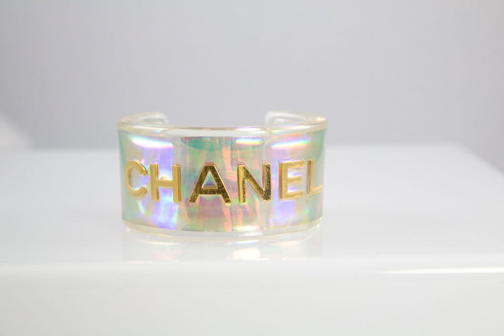 A bold Chanel lucite cuff inset with gold plated letters that spell 