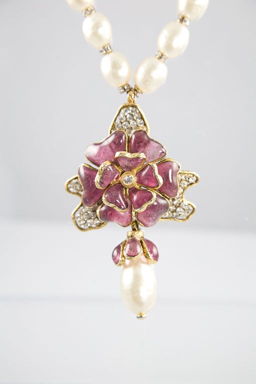 Beautiful and rare sautoir comprised of beautiful glass pearls separated by rhinestone set rondels.  At the end of the pearls, a Maison Gripoix poured glass camellia is bezel set and accented by rhinestone leaves.  This is completed by the addition