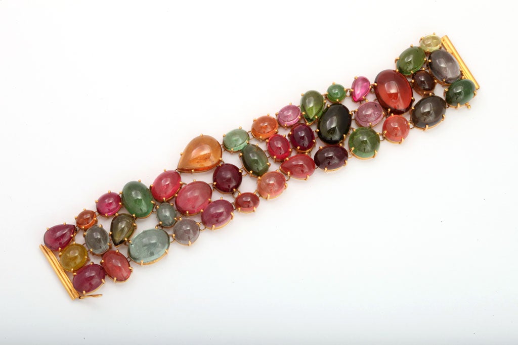 18kt Yellow Gold Handmade Bracelet set with Multi-color Pink, Green Amber Blue & Green Cabochon Tourmalines. Contemporary.  Each Tormaline hand set in a Pronged Basket setting.