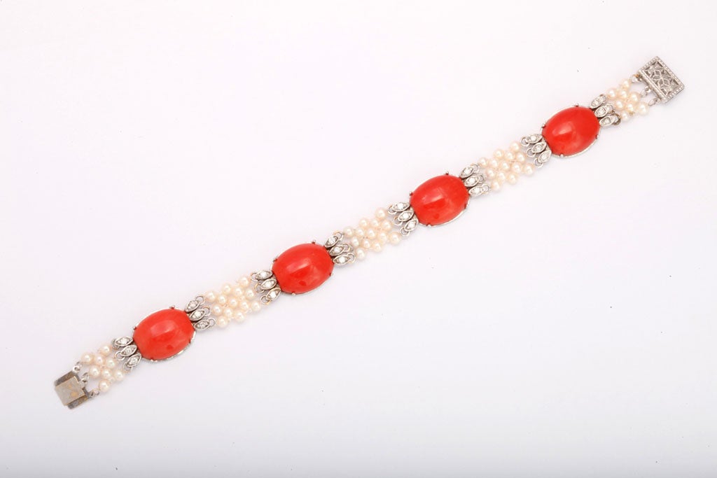 14KT White Gold, Coral & Diamond  Bracelet.  Custom made in the 50's with carefully selected oval Coral Cabochons set on a white gold setting & terminating with full cut Diamond spacers - then joined by woven Cultured Pearls.