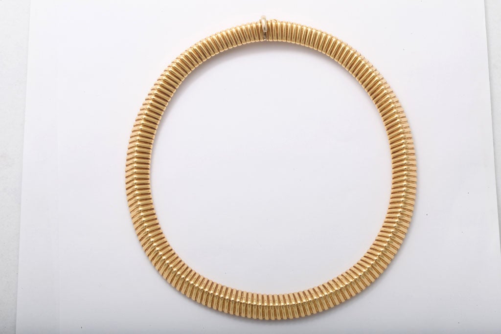 18KT tubular necklace with a twist.  Pyramidal shape with a tab closing.  Very elegant & different. Over 80dwts.