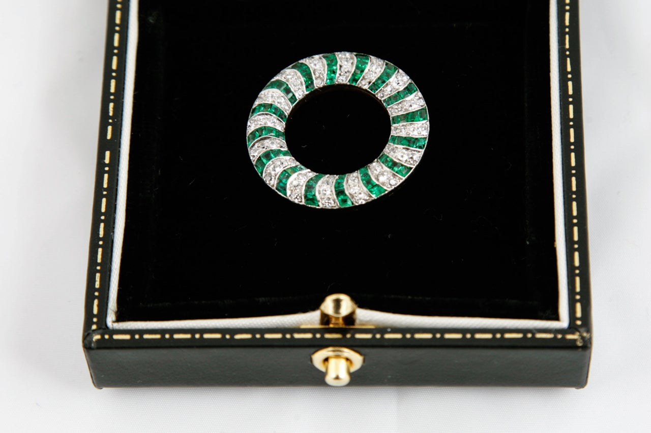 Platinum and yellow gold mounted,open circle brooch set old cut diamonds and shaped emeralds,French ,c,1920