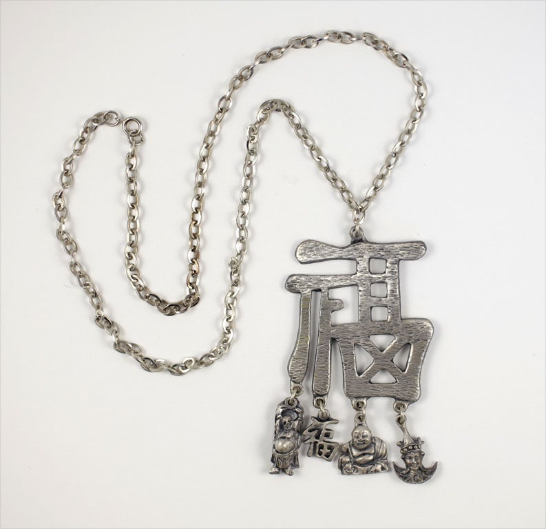Chunky Chinese character pendant necklace with four dangling charms.