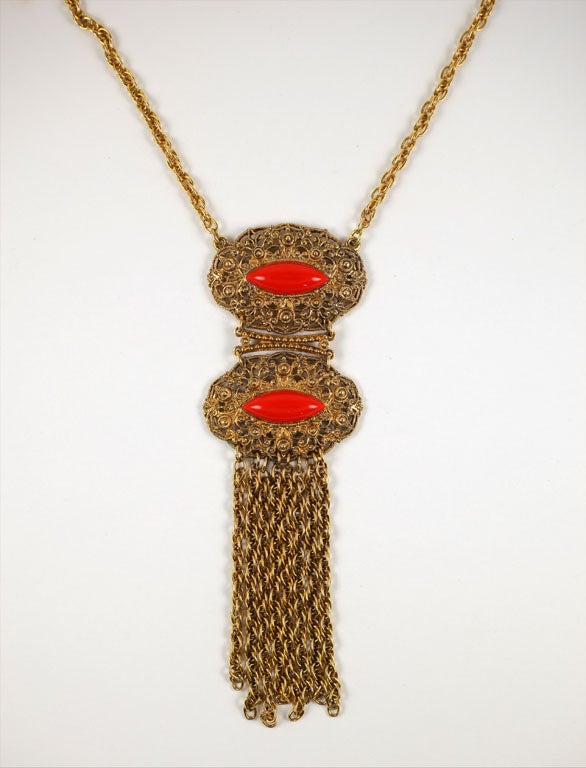 Double medallion fringed pendant necklace with faux coral embellishments.