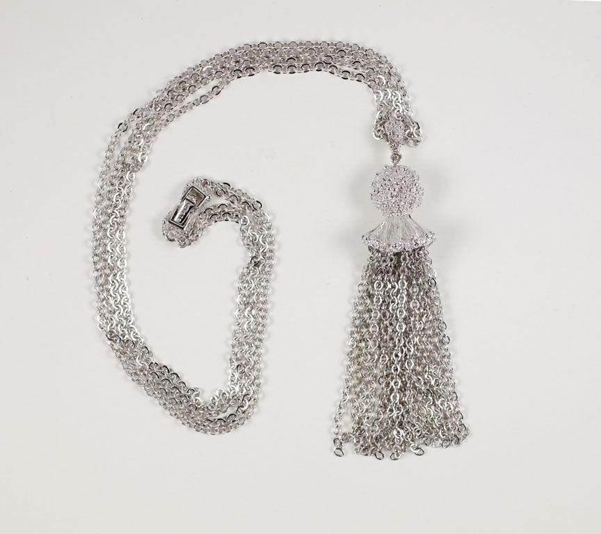 Double chain silvertone necklace with a textured cap multi chain tassel.