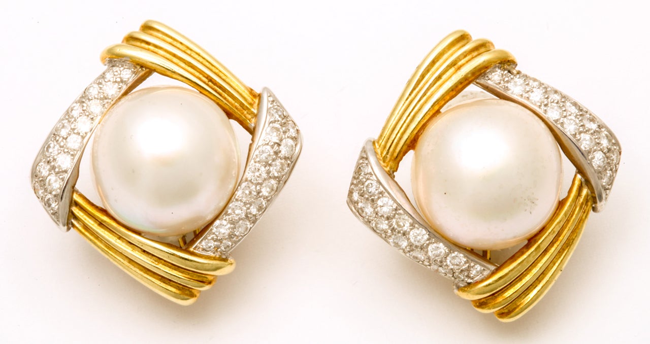 18kt yellow textured yellow gold high quality clip on earrings consisting of approximately 2 carats of full cut diamonds and centering very high quality and high luster mabe pearls approximately 20mm signed Gucci