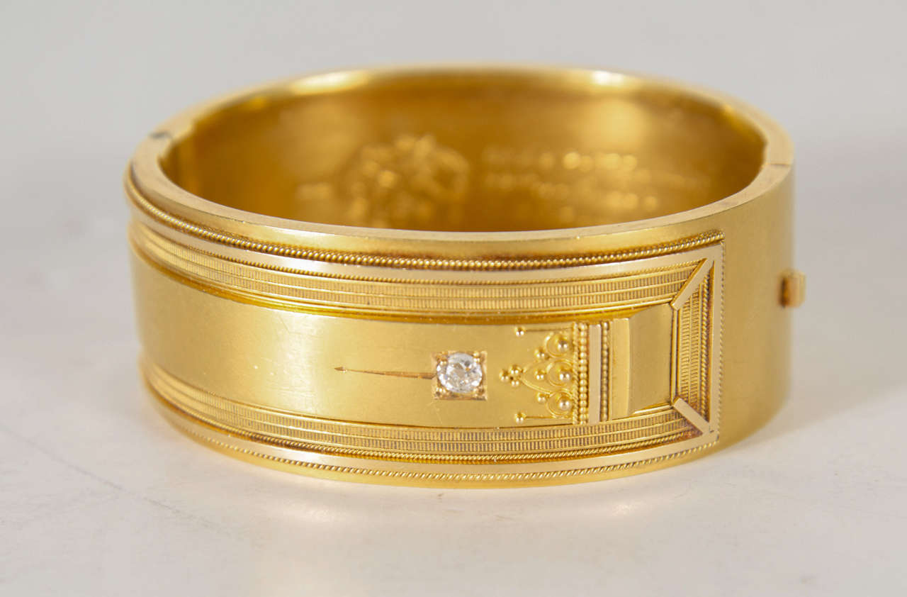 This stunning cuff bangle bracket is 18k yellow gold set with a diamond of approximately 10pts. It has exquisite Victorian relief Eastlake style detailing. This is a finely made piece that has been engraved on the inside for a Birthday present dated
