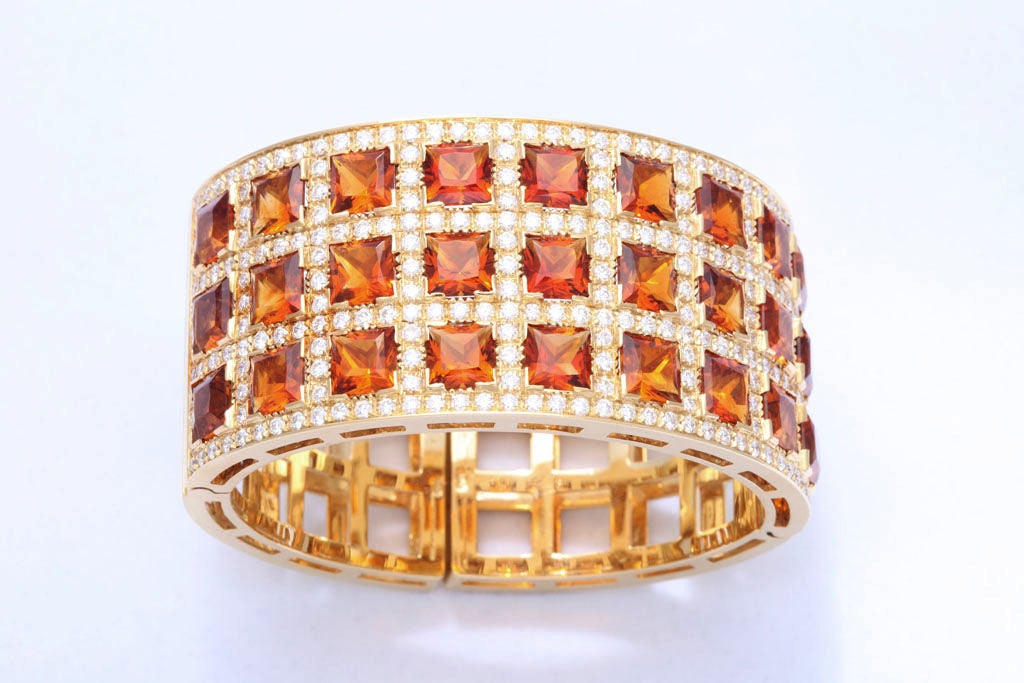 18k yellow gold cuff bracelet with spring hinges  124 grams<br />
234 round diamonds 7.47<br />
27 faceted top square citrines 46.10 carats