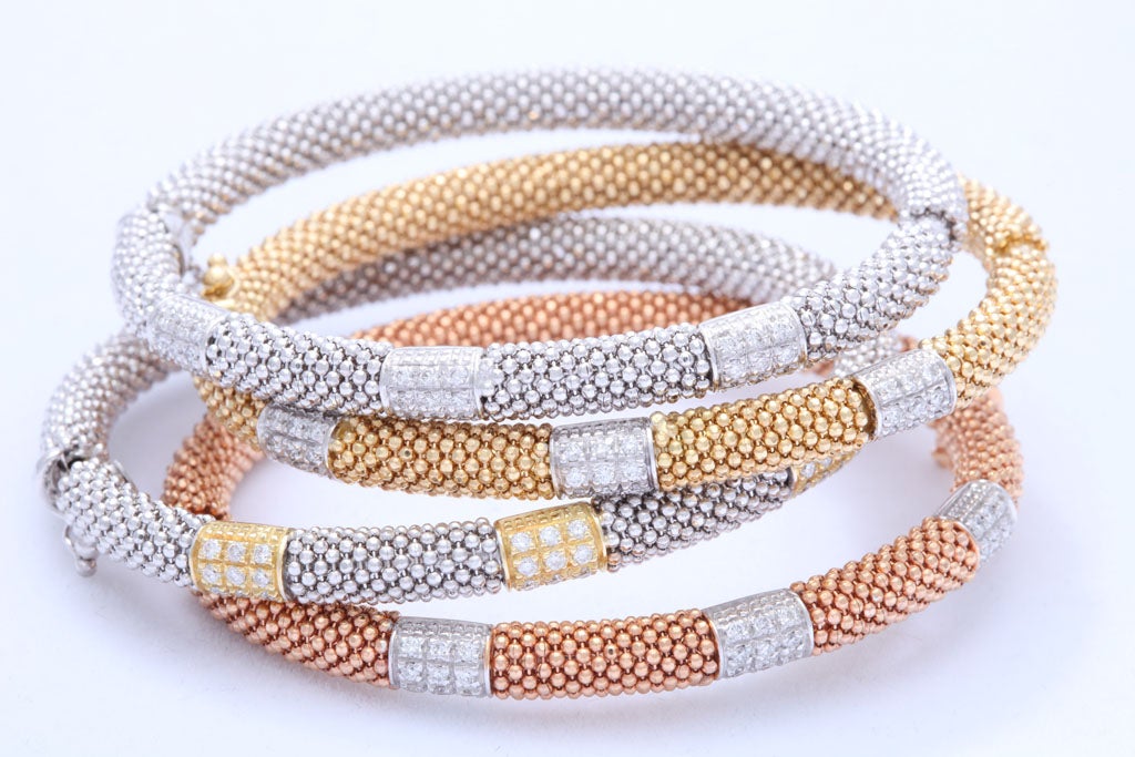 set of 4 18k gold and diamond bracelets<br />
each set with 27 diamonds approximate weight 0.50 carats<br />
each weighing 26.5 grams<br />
may be purchased individually or in groups