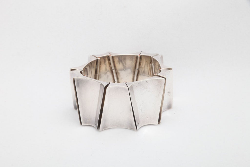This monumental bracelet is a work of art. No other jewelry is necessary when wearing this sterling silver bracelet of alternating deeply curved trapezoid forms. Simply spectacular! Attributed to the famed Mexican jeweler Antonio.