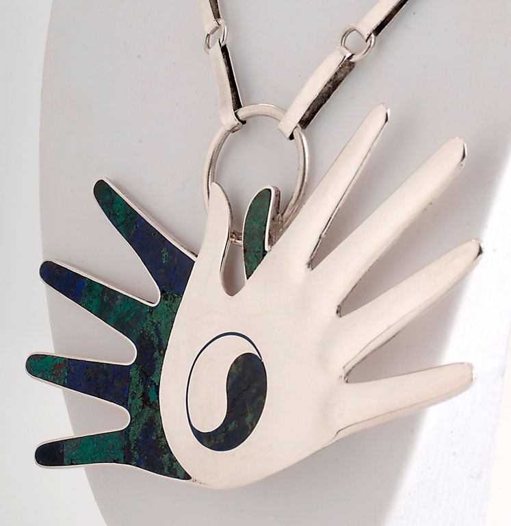 Yin Yang Hands Necklace by William Spratling done in sterling silver and azur malachite.One of Spratling's iconic designs in which the hands have a positive/negative effect in addition to the traditional yin/yang symbol. Imposing size - measures 5