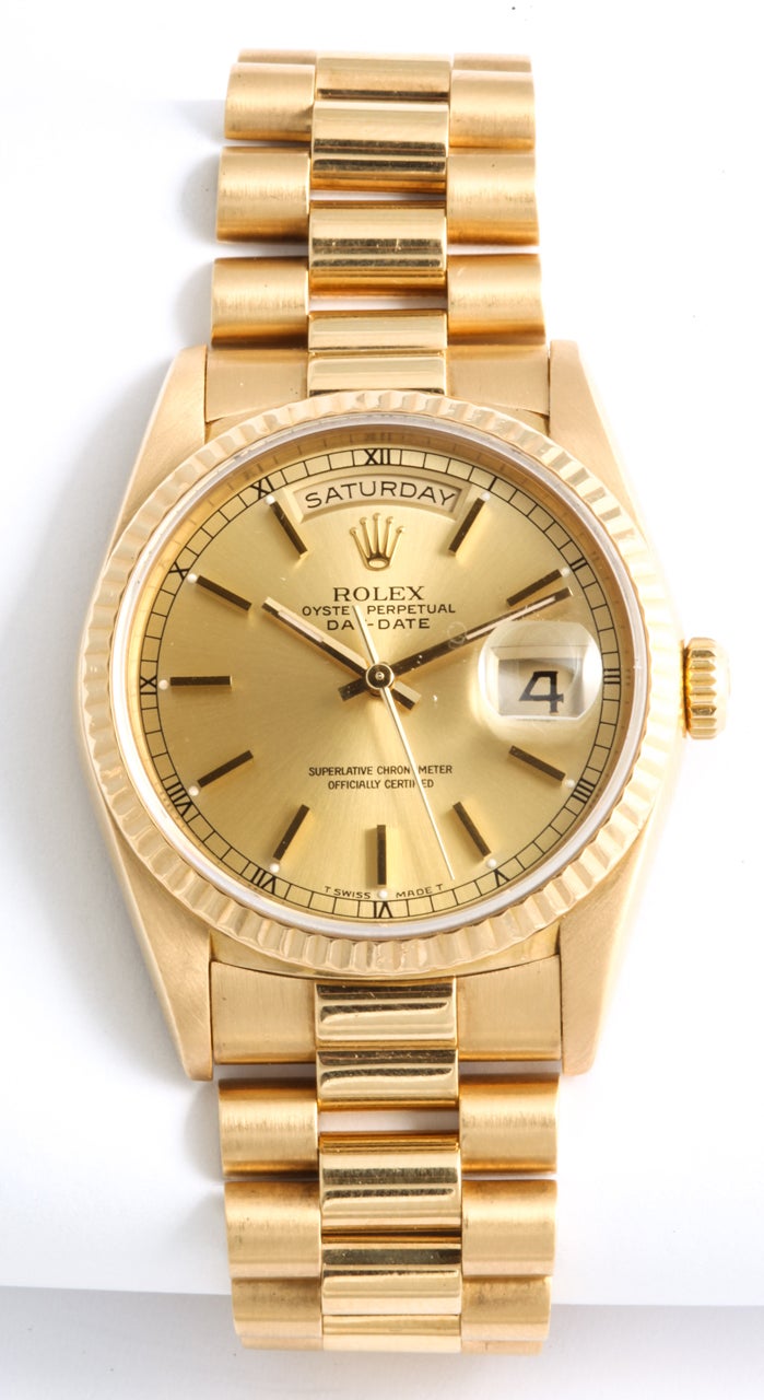 Rolex Oyster Perpetual Day-Date President
Metal: 18k Yellow Gold
Dial: Champagne Tapestry Baton
Bezel:  Gold Fluted Bezel
Movement: Automatic 
Case: 36mm 
Crystal: Scratch Proof Sapphire Crystal 
Warranty: One Year Warranty