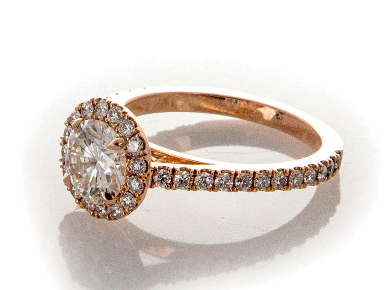 Beautiful transitional Ideal cut round diamond with fantastic brilliance cut the old fashioned way, with extra diameter and a little less depth. Circa 1940.  Not done any more because of less weight yield. Peter Suchy design round groove set Halo