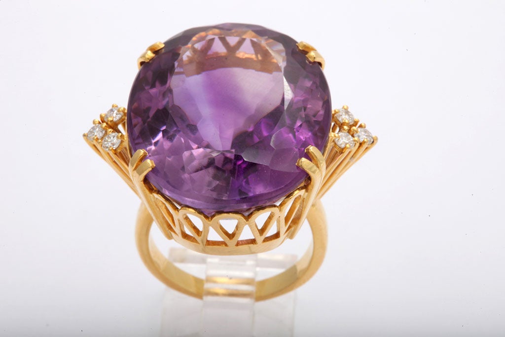 30 Carat Scissor Cut Amethyst in 18KT Gold Open Work Setting with Diamonds on the sides.