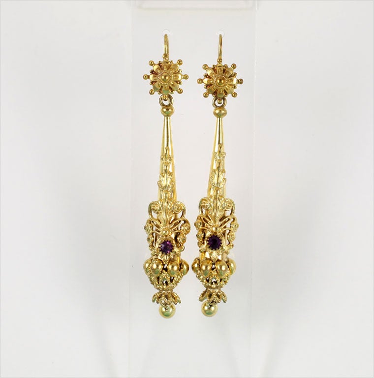 Long, light, with gold worked in repousse and cannetille, these torpedo earrings of 15kt gold are gem set with amethysts, abundantly jubilant, yet just perfect for daily use or dressed up occasion. Reposse is the method of hammering the gold forward