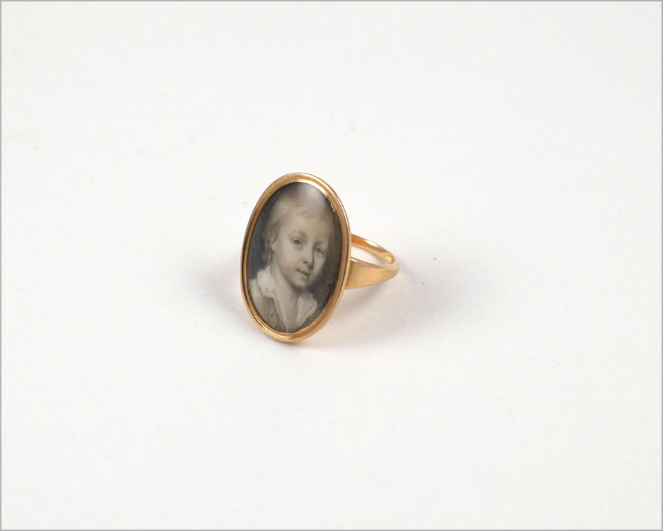 Our gold ring holds a small portrait of a British boy lovingly drawn with marvelous skill in subtle shades of black and gray and white. The artist's hand was so accomplished that we can tell the child is blond although no golden color is used<br