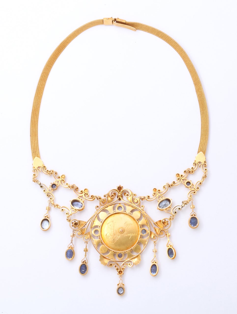 Magnificent. I can stop here and let your eyes do the rest.
The necklace:  An 18kt gold with natural sapphires and natural pearls, centered with a gold cameo plaque on which the beautiful form of a woman is engraved. Her cape is flowing as she