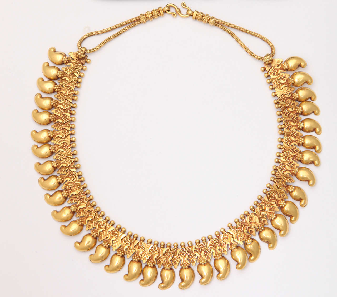 22kt Indian Necklace on woven wire closing.  Usually given as dowry gifts & worn by Brides. Rare and usually never parted with by families.  Paisley pendant motifs  making a rich & sumptuous collar further embellished by a rich gold collar.