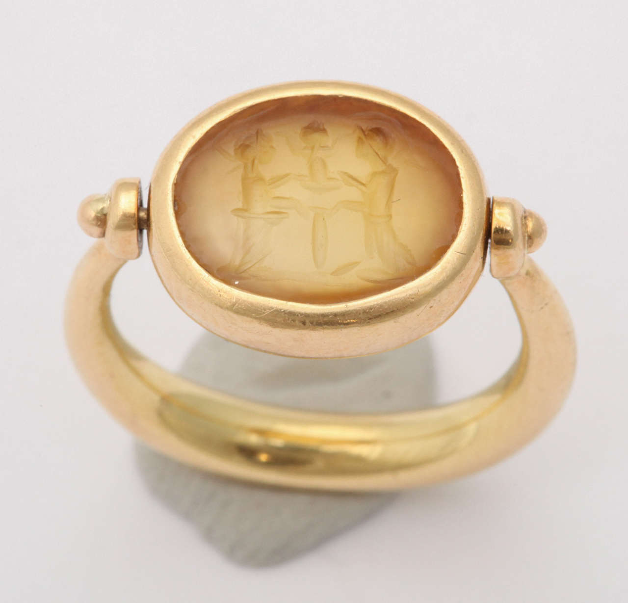 Splendid Pinky  Ring set in Oval 18kt Yellow Gold swivel mounting. Lovely Intaglio of two opposing Gods & a central Figure.
Inscribed Roma  2 sec d C & 750 & control numbers.