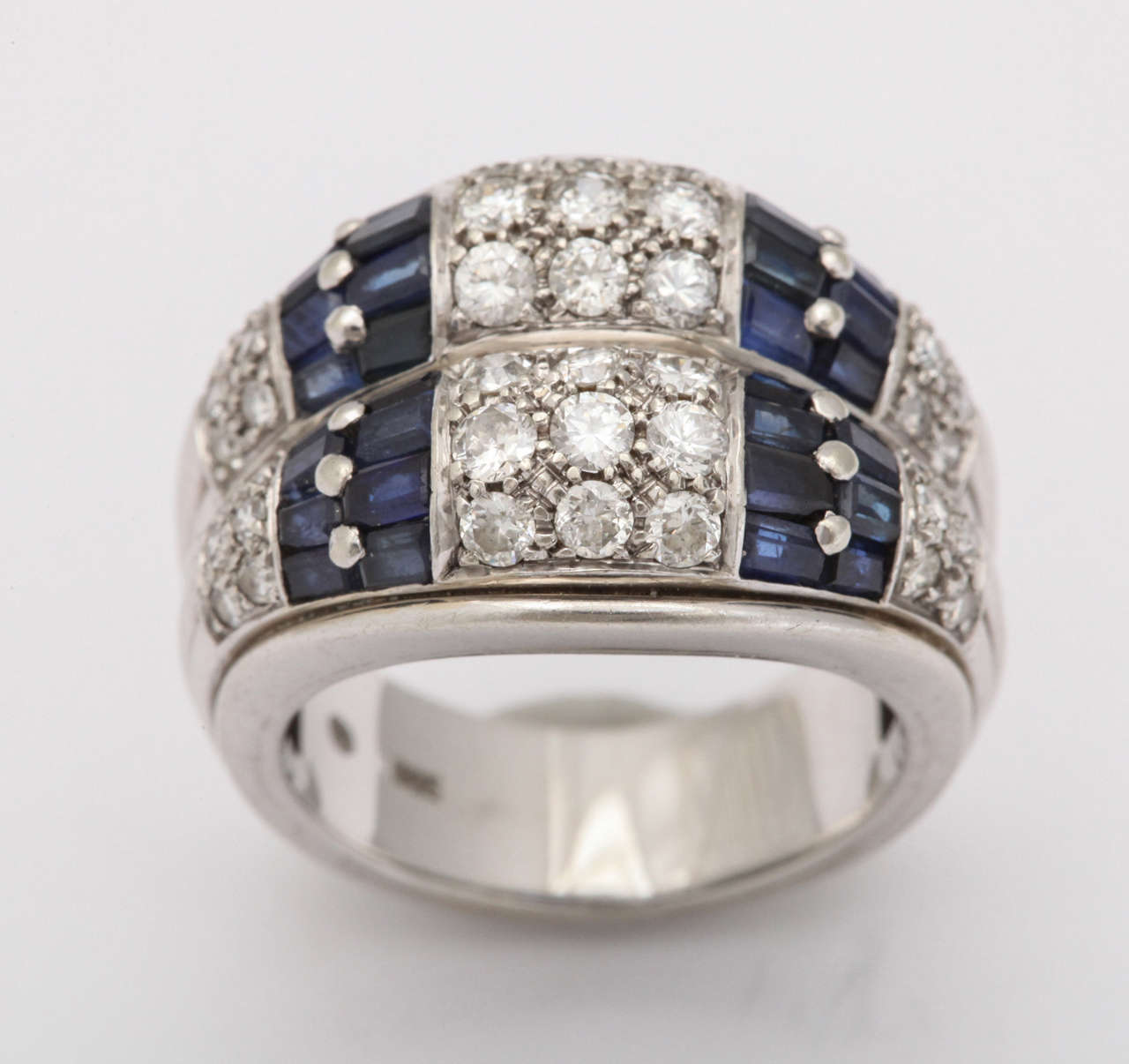 Beautiful 14kt White Gold double Band each set with three rows of prong set full cut - clean white Diamonds  - a total of 18 Stones & separated by a  row of faceted Sapphire Baguettes - each row set with sixteen Sapphires.  The quality & intensity