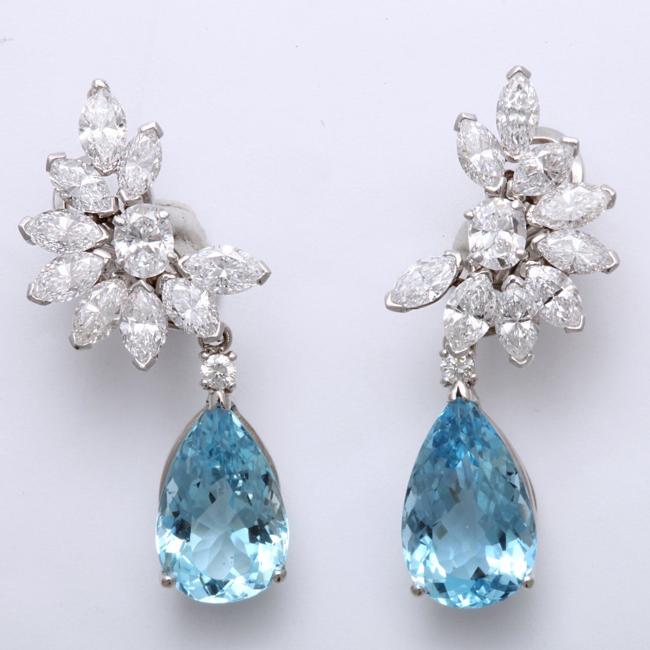 Platinum Diamond and Aquamarine Floral Day Night Earrings. These day and night earrings featured beautiful Aquamarines and Diamonds. Approximately 7ct of Diamonds and approximately 25ct of Aquamarine. Length - 1 9/16