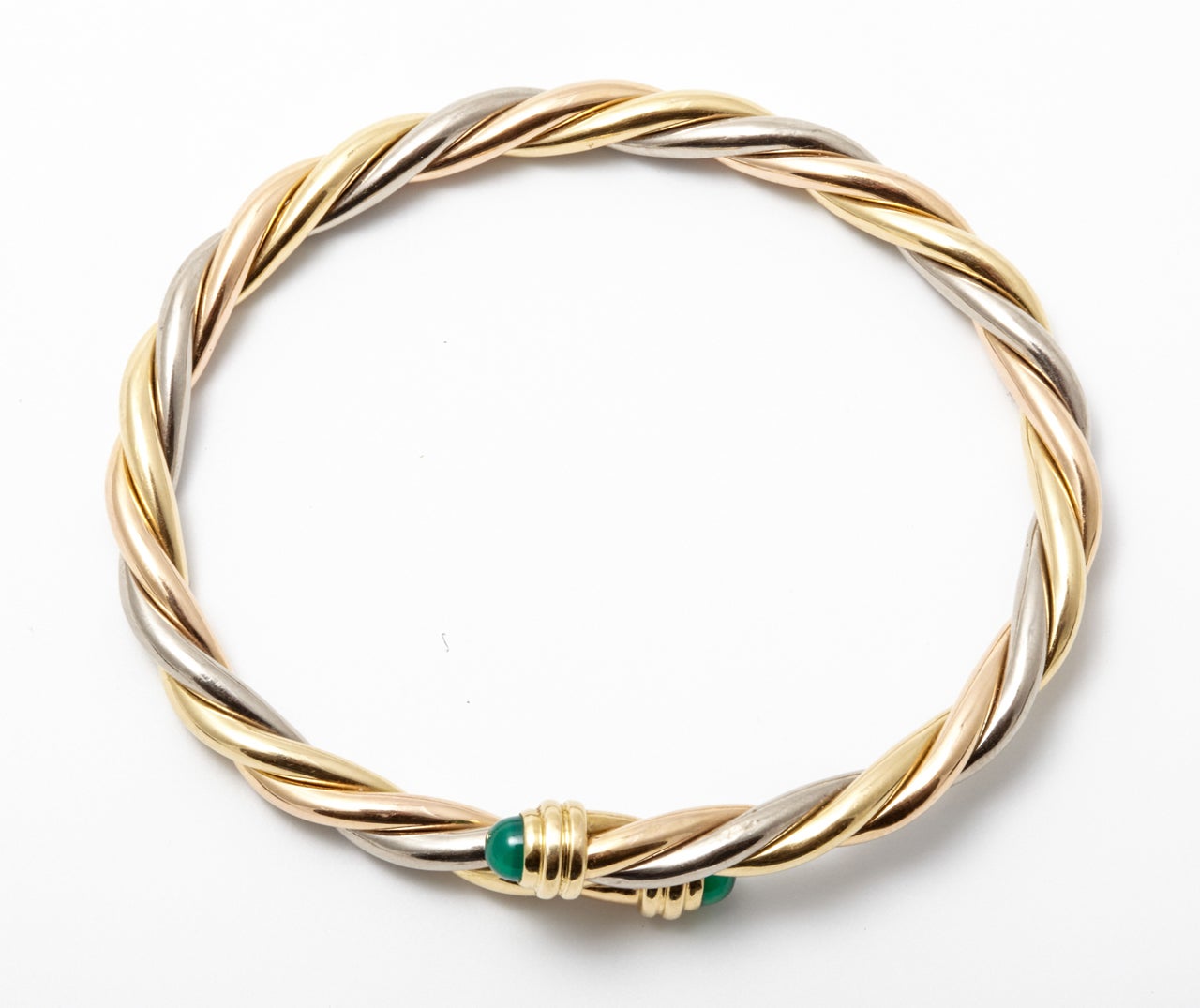 A modern 18kt yellow, rosé and white golden intertwined bracelet, terminating at each end with a dome cut green chalcedony. Engraved Cartier 750 D00841. Wrist size is 20 cm / 7.87’

All of our prices exclude VAT.