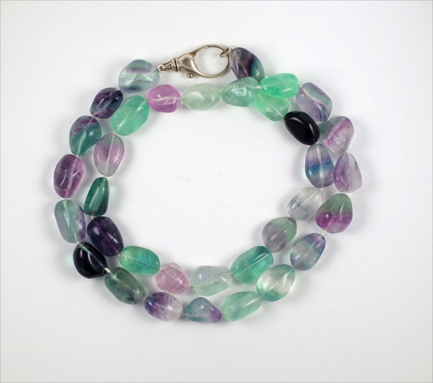 34 aqua, lavender, clear irregular shaped stones strung and knotted as a necklace. Colors are softer than in the photos. One stone has a chunk missing, however it is not easy to find it. 