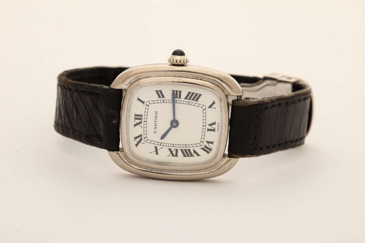 A wonderful lady's 18k white gold Cartier manual-winding elliptical wristwatch, with original 18k white gold folding deployant closure. This watch in white gold is exceptionally hard to find in such original condition.
