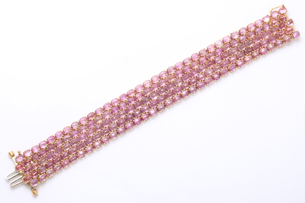 18kt Yellow Gold Bracelet set with five rows of fancy cut Pink Sapphires totaling approximately 70 cts. Just enough to put you in the right uplifting mood! Bright & sassy. 7