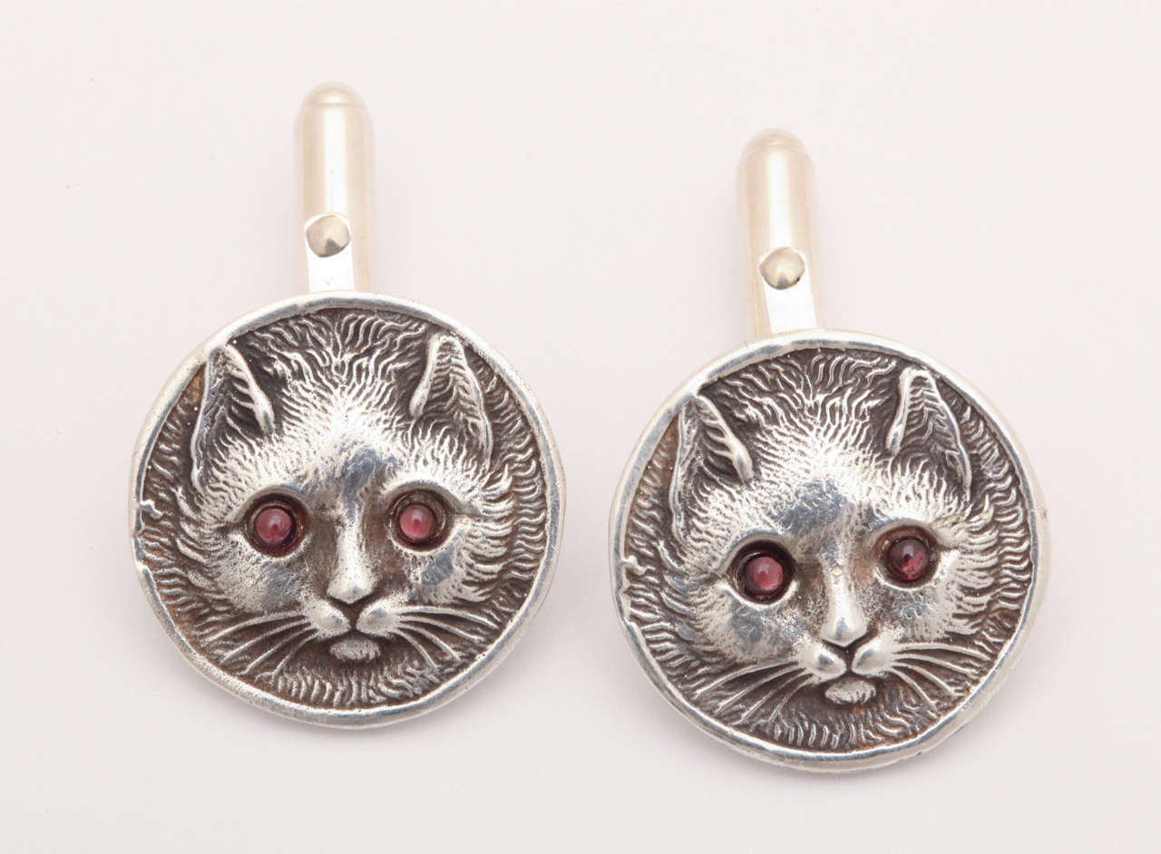 Glowing  eyes, whiskers and a furry mane stand out in deep relief on winsome feline cufflinks for the many cat lovers among us. I am one and am so tempted to have these as a pet. The face is the size of a silver nickel. The back is the easy to use