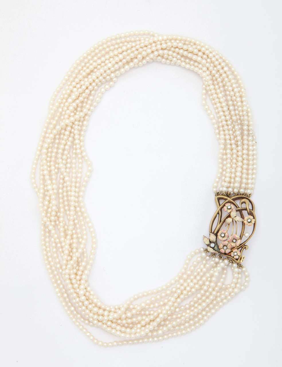 This soft, feminine 12 strand, 3mm round fresh water pearl necklace is timeless and drapes beautifully around the neck.

The handmade clasp is adorned with flowers and leaves that are enameled with opalescent and peachy-pink  enamels. The gold is